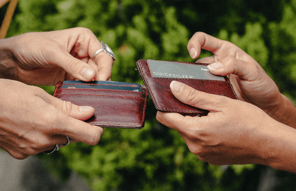 a couple of people that are holding some wallets